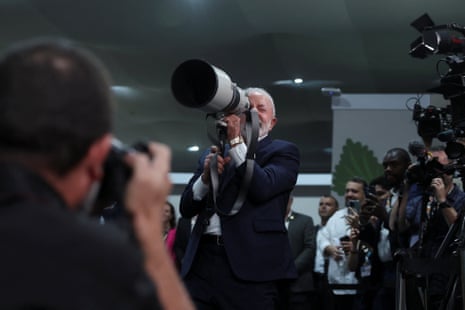 Brazil’s President Luiz Inacio Lula da Silva holds a camera lens during his visit to the UN Climate Change Conference (COP30), in Belem, yesterday