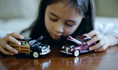 Girl plays with toy cars
