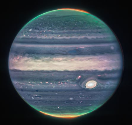 This image of Jupiter, taken by the James Webb Space Telescope, shows the planet's weather, tiny moons, altitude, cloud cover and auroras at the north and south poles.