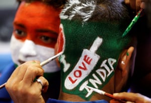 A fans get his hair painted in Mumbai to show his support for the India before watching the match against Pakistan.
