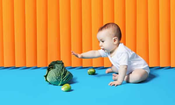 Baby reaching for greens