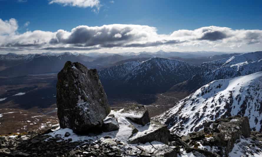 Glencoe - an icy oasis. Walker and skiers enjoy the peace of sunny still weather on the summit of Meall a Bhuiridh mountain (1108m).