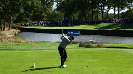 Rory McIlroy chips to the green during the first round