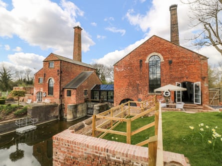Two old redbrick buildings by a canal