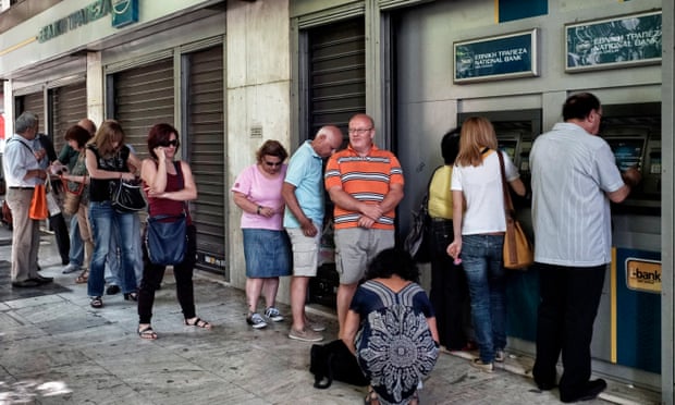 People wait in line to withdraw €60