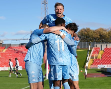Dominic Johnson-Fisher is mobbed by his Truro City teammates after scoring the opener