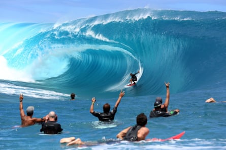 Fellow surfers and filming crew react during the shooting of a remake of the film Point Break in the Hava’e pass in Teahupoo.