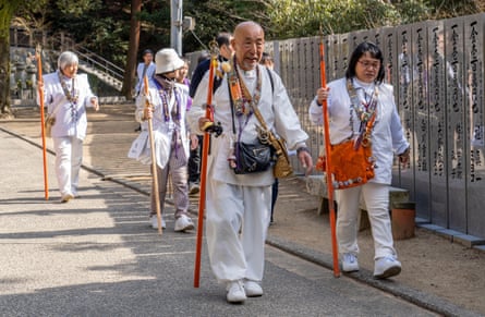 Buddhist pilgrims dressed in white walk