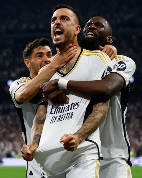 Real Madrid's Joselu celebrates scoring their first goal with Antonio Rudiger.