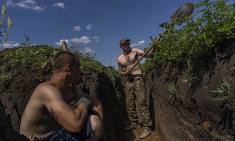 Ukrainian servicemen dig trenches near the frontline in Donetsk region