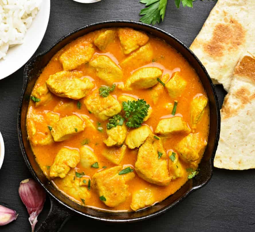 Indian chicken curry on black stone background