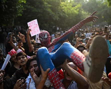 A protester dressed as Spider-Man is lifted by fellow gen-Z demonstrators.