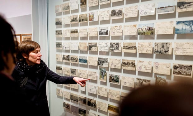 Visitors look at a wall of postcards in the new exhibition, German Colonialism. Fragments Of Its History And Present, at the German Historical Museum.