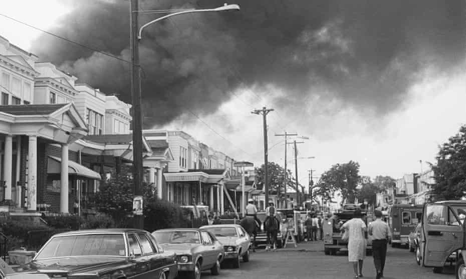 Smoke billows over rowhouses in West Philadelphia after the 1985 bombing.