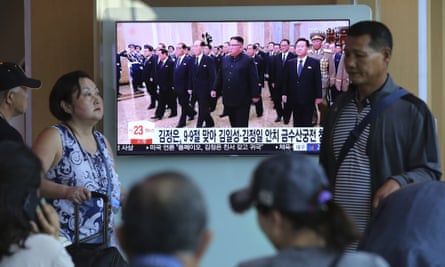 People watch a TV screen showing North Korean leader Kim Jong-un, centre, visiting the Kumsusan Palace of the Sun.