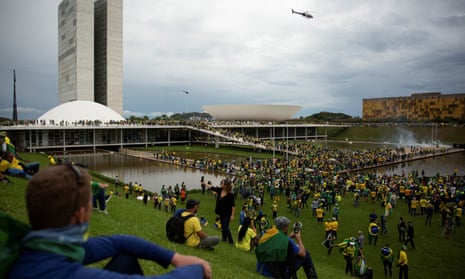 Supporters of Brazil’s far-right former president Jair Bolsonaro gather outside congress after invading the building as well as the presidential palace and supreme court, in Brasília