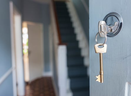 Front door of house with key in lock