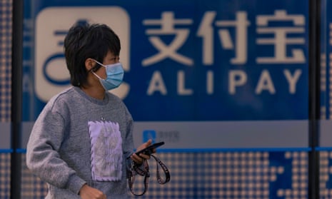 A woman walks in front of the Alipay building in Shanghai, China