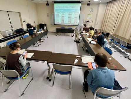 The learners sit around at desks in the training room
