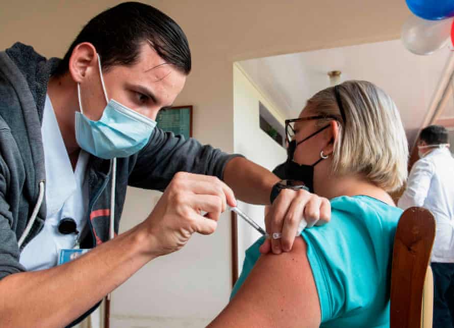 A healthcare worker administers a Covid-19 vaccine to a woman at the Casa Israel Geriatric Residence Center in Cartago, Costa Rica, on 12 January, 2020.