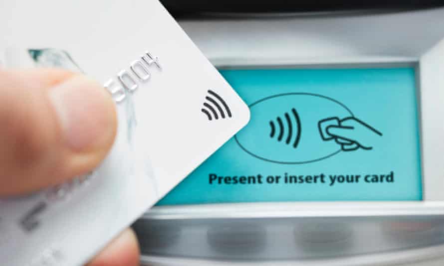 Close-up of a credit card being used to make a payment on a contactless card machine
