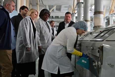 US representative to the UN, Ambassador Linda Thomas-Greenfield (C) meets with workers during her visit in KyivMlyn flour mill in Kyiv. US ambassador to Ukraine Bridget Brink stands to her right.