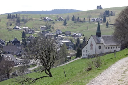 The church on a hillside and other buildings in a valley below