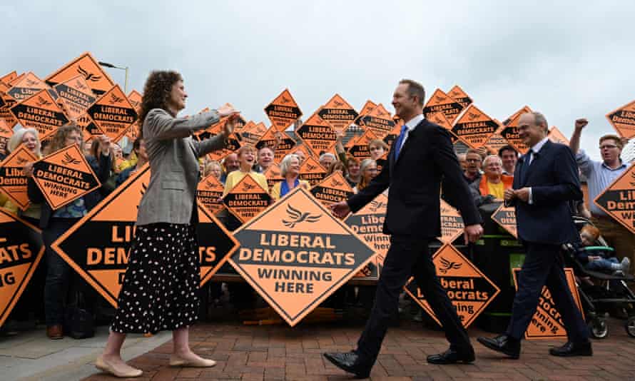 Britain’s centrist Liberal Democrats party leader Ed Davey (R) and newly elected MP Richard Foord (C) are greeted by the party’s chief whip Wendy chamberlain (L) in Tiverton.