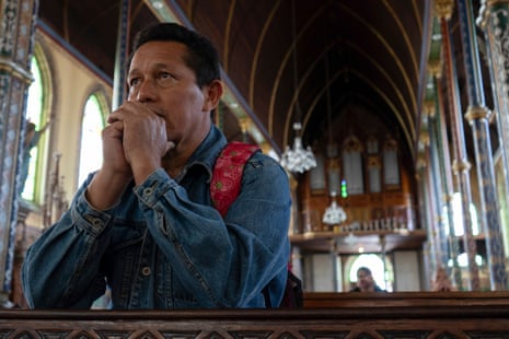 Raul Oporta, 53, praying inside La Merced church in San José.