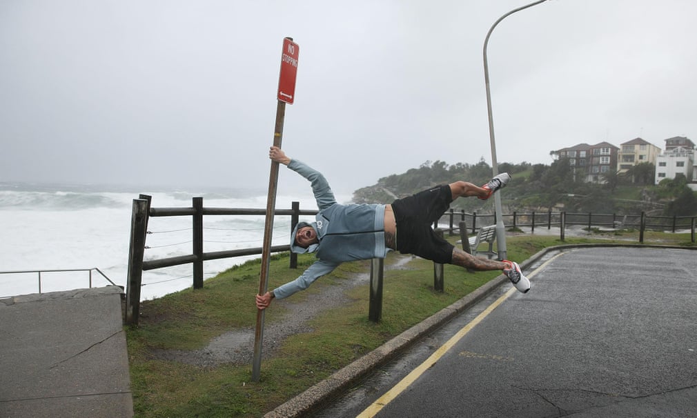 A man fools around in the wind at Bondi Beach, Sydney, on April 21 2015.