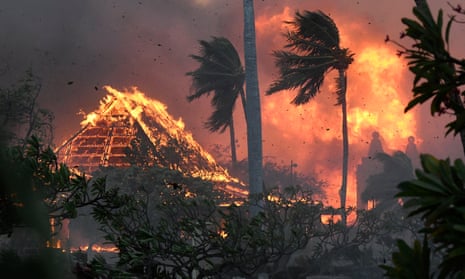 A church and palm trees engulfed in flames in Lahaina, Hawaii