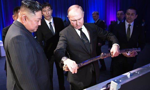 Vladimir Putin presents a sabre to Kim Jong-un.