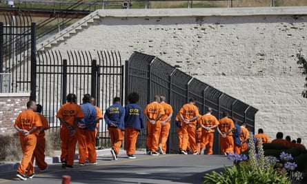 Incarcerated people walk in a line at San Quentin state prison in California.
