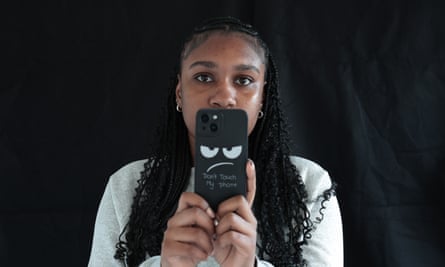 Rianna Montaque holding up a phone and looking at the camera