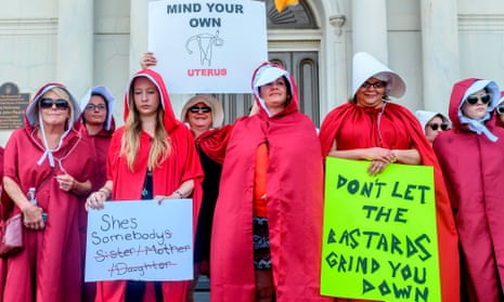 Activists dressed as handmaids protest the abortion ban in the French Quarter of New Orleans, Louisiana, on 25 May. 