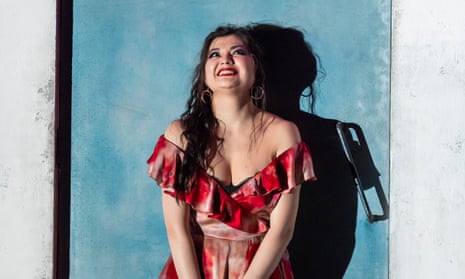 a smiling Aigul Akhmetshina as Carmen at the Royal Opera House, in a low-cut, off-the-shoulder red dress
