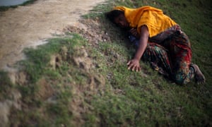 Rohingya refugee lies on the ground