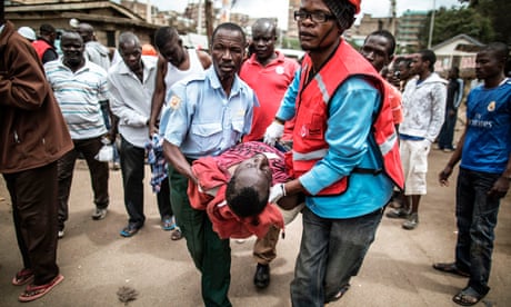 Kenya Red Cross workers carry away a wounded man.