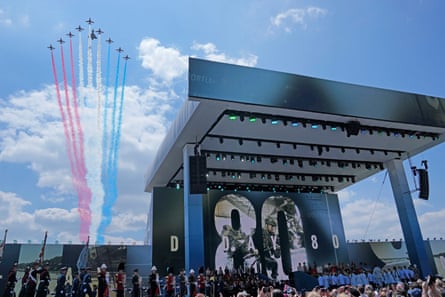Aircraft with red, white and blue trails behind the stage.