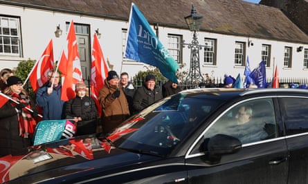 Car passing picketing teachers