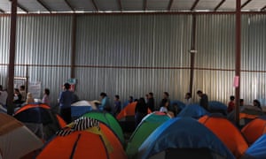 Asylum seekers wait for food inside a shelter in Tijuana, Mexico on 6 April.