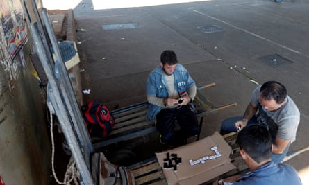 Workers play dominoes at a São Paulo warehouse
