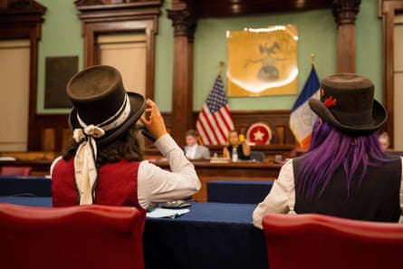 carriage horse drivers with hats sit at a table