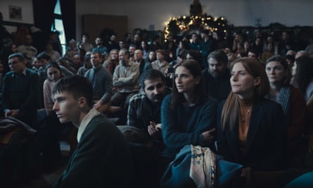 group of people sitting in a room in a film still