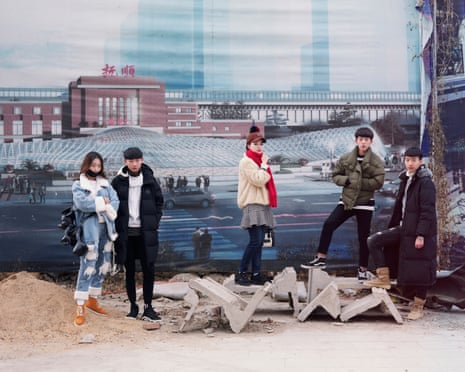A group of students who are about to take an art exam stand in front of promotional posters in an image from Freezing Land