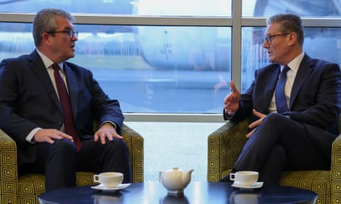 Starmer gestures as he talks to Hewitt. The two men are seated opposite each other