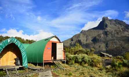 Climbers sleep in static tents or wooden huts, spacious enough for bunkbeds
