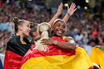 Jamaica’s Shelly-Ann Fraser-Pryce embraces runners from the Germany team after claiming a silver medal in the final of the women’s 4x100m in what was the last race of her career.