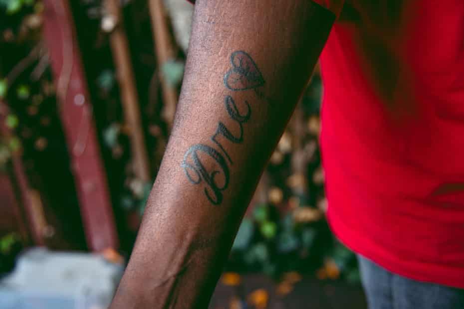 André Robinson Sr shows a tattoo on his arm in memory of his late son André Robinson Jr.