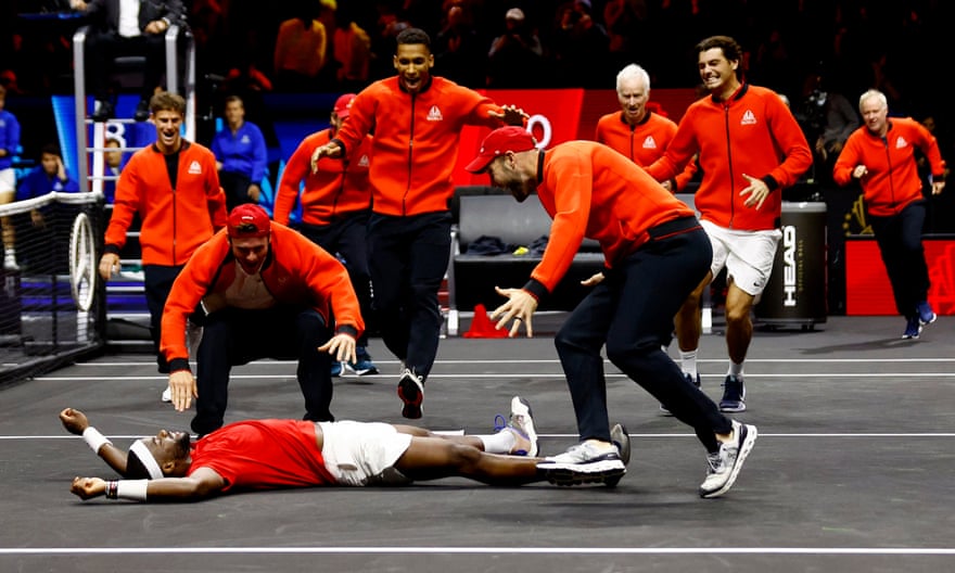 Frances Tiafoe celebrates with his Team World teammates after winning his match and the Laver Cup